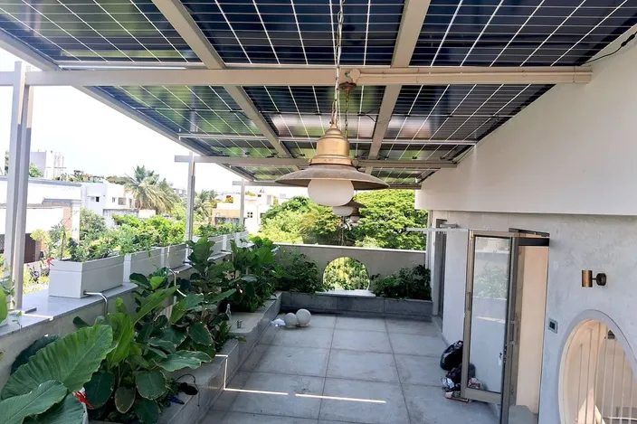 Bifacial solar pergola over a landscaped terrace at a Chennai residence